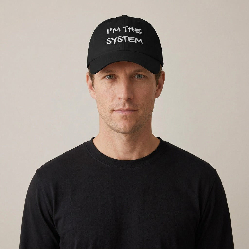 Model wearing the I'm the System embroidered dad hat in black