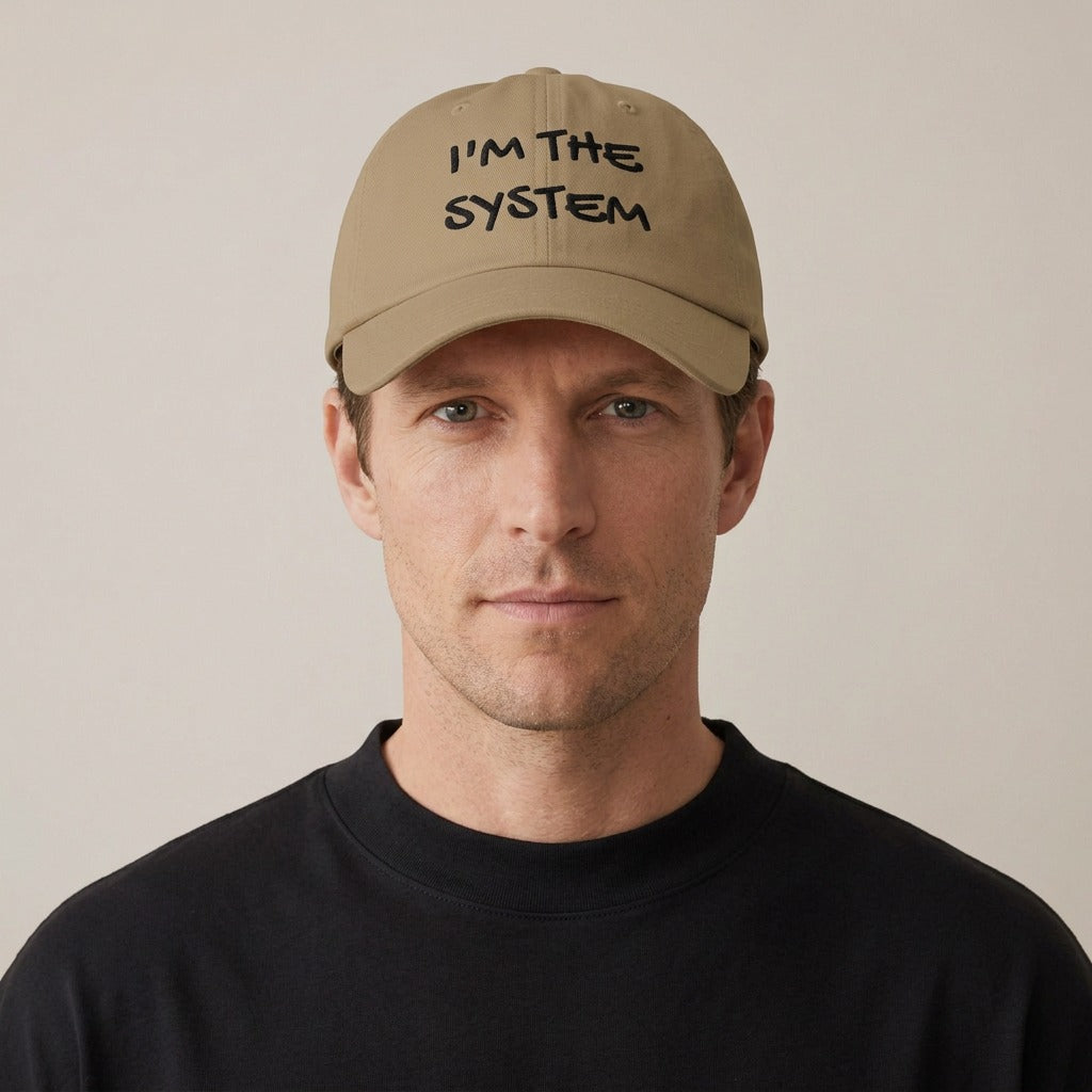 Model wearing the I'm the System embroidered dad hat in khaki