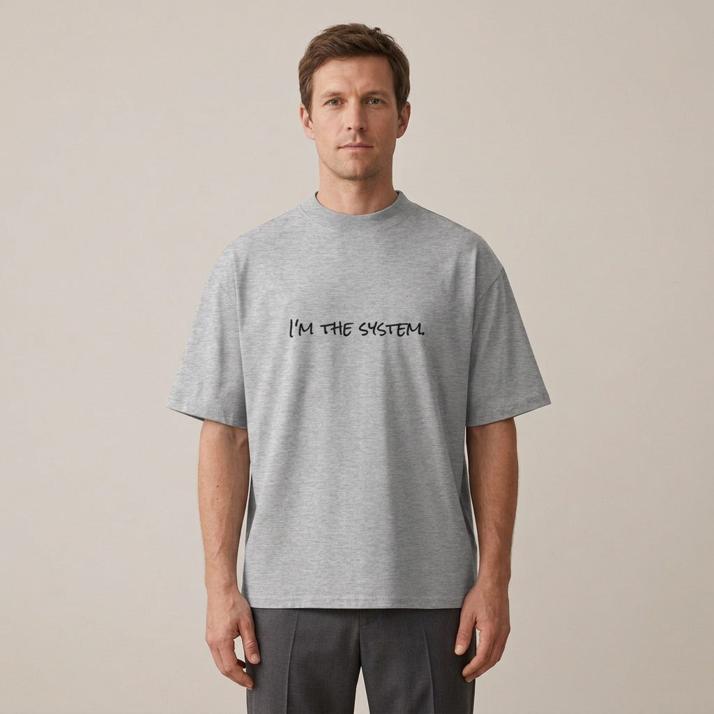 Model wearing the I'm the System. t-shirt in heather grey
