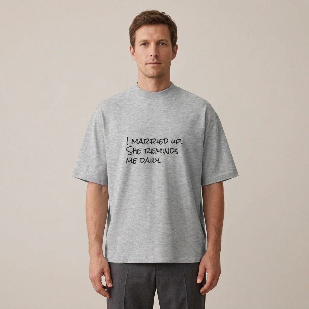 Man wearing the I Married Up. She Reminds Me Daily. t-shirt in heather grey